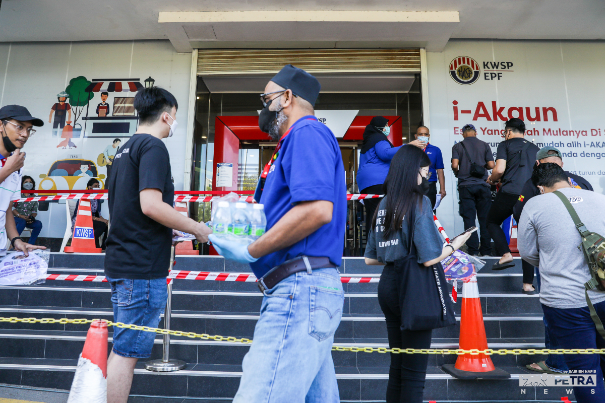 Orang ramai beratur dan menunggu giliran di pejabat KWSP, Seksyen 25, Shah Alam.