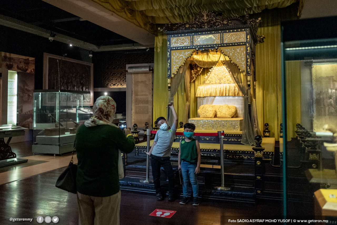 Dua kanak-kanak ini tidak melepaskan peluang untuk bergambar di depan bahan pameran dalam Muzium Negara.