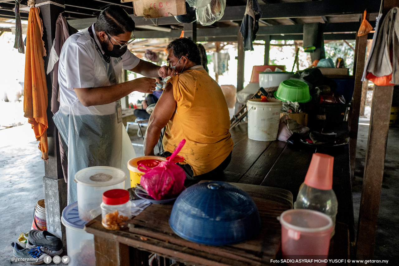 Seorang lelaki mendapat suntikan vaksin daripada petugas kesihatan menerusi Program Mobile Outreach.