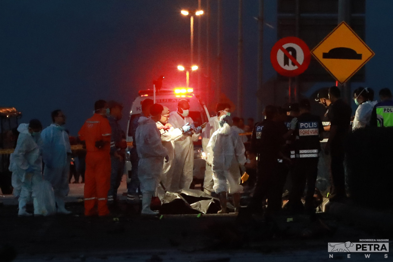 Anggota penyelamat dan forensik mengumpul serpihan mayat dan pesawat di tapak tragedi berdekatan Bandar Elmina, semalam. gambar Nooreeza Hashim