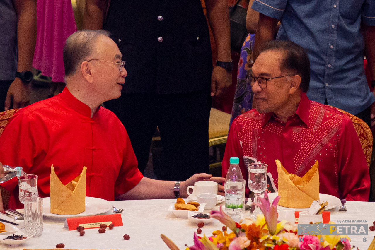 Anwar berbual dengan Wee Ka Siong ketika hadir pada Majlis Rumah Terbuka Tahun Baharu Cina MCA di sini hari ini.