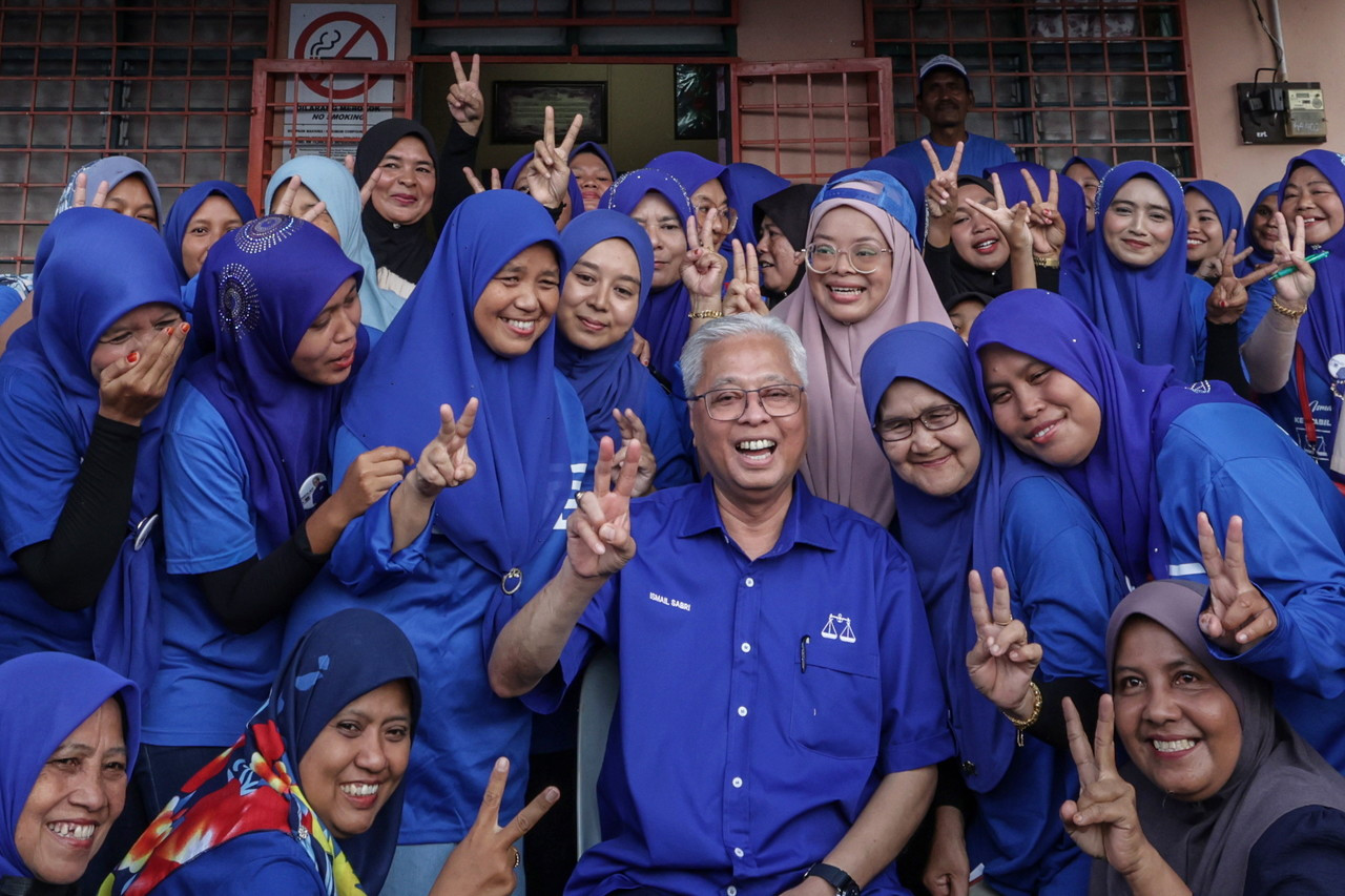 Penduduk Felda tidak melepaskan peluang bergambar bersama Perdana Menteri yang juga Calon Barisan Nasional bagi Parlimen Bera ketika beliau hadir Program Moh Ngeteh bersama Penduduk Felda Purun. - Gambar Bernama 