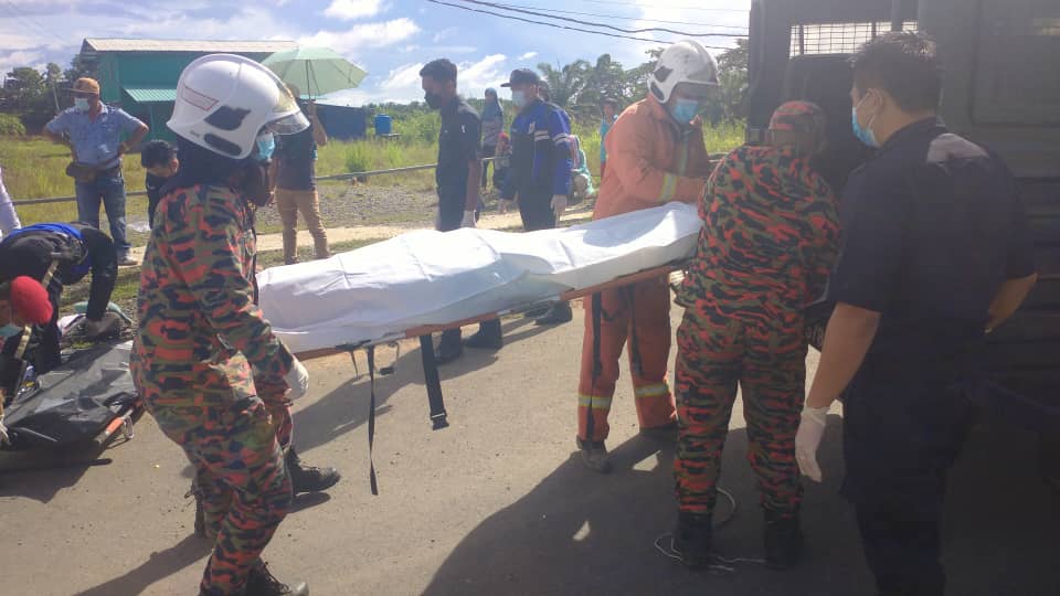 Anggota Bomba mengusung mayat mangsa kemalangan di Jalan Kampung Segaliud Seberang, Kinabatangan, hari ini.
