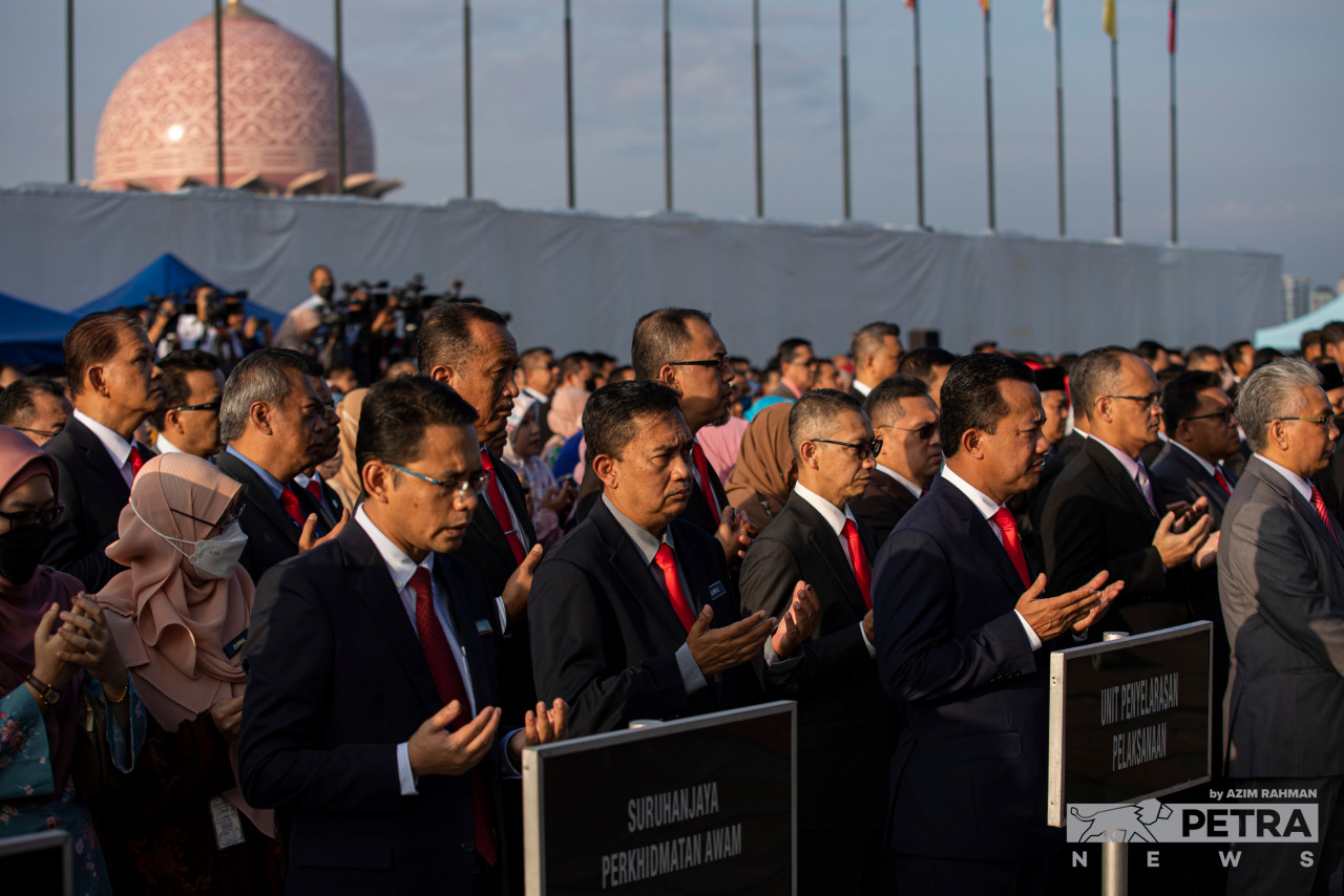 Warga JPM mengangkat tangan ketika doa dibacakan pada perjumpaan pertama mereka dengan Anwar di Putrajaya, hari ini.